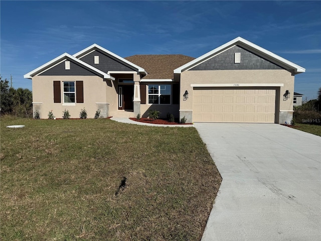 view of front of home featuring a garage, concrete driveway, a front lawn, and stucco siding