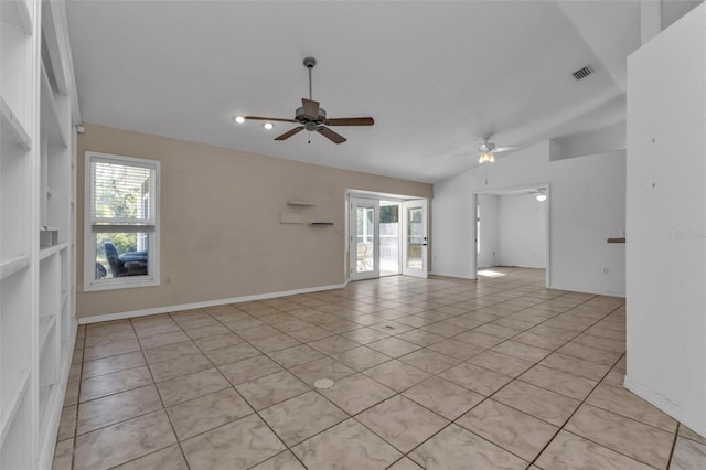 tiled empty room featuring ceiling fan, a healthy amount of sunlight, and vaulted ceiling