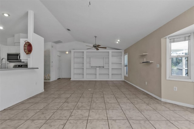 unfurnished living room with sink, vaulted ceiling, ceiling fan, built in features, and light tile patterned flooring