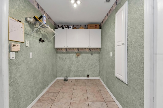 washroom with cabinets, hookup for a washing machine, electric dryer hookup, and light tile patterned flooring