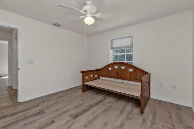 bedroom with light wood-type flooring and ceiling fan