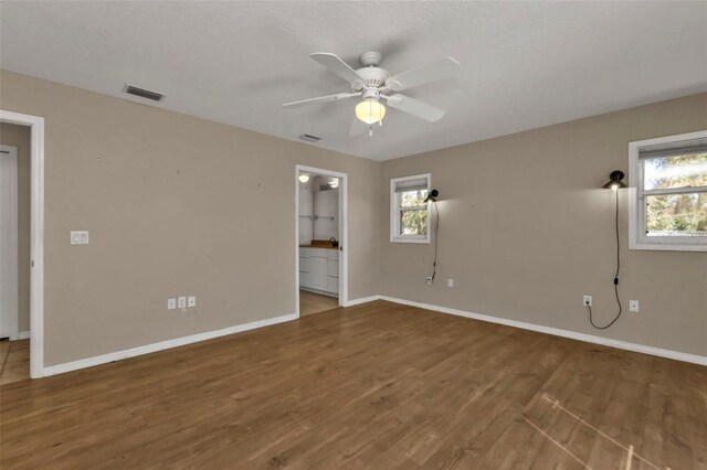 spare room with ceiling fan and wood-type flooring