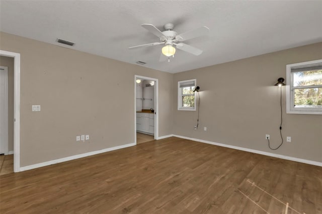 1811 Music Ln, North Port, FL 34286 - unfurnished room with baseboards, wood finished floors, and a ceiling fan