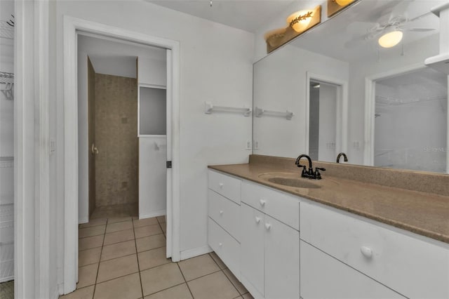 bathroom with tile patterned flooring, vanity, and ceiling fan