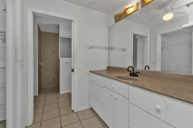 1811 Music Ln, North Port, FL 34286 - bathroom with a spacious closet, vanity, tile patterned floors, and ceiling fan