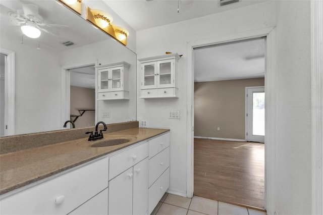 bathroom with ceiling fan, hardwood / wood-style floors, and vanity