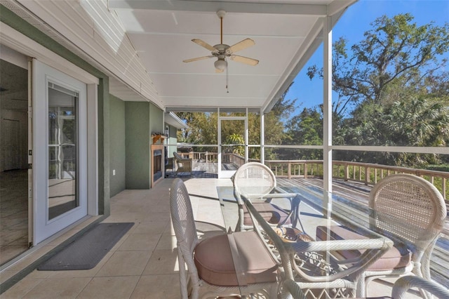 sunroom / solarium featuring ceiling fan and plenty of natural light