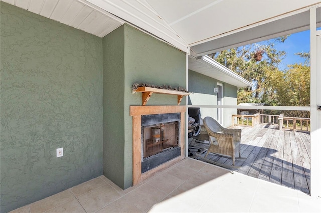 wooden terrace featuring exterior fireplace