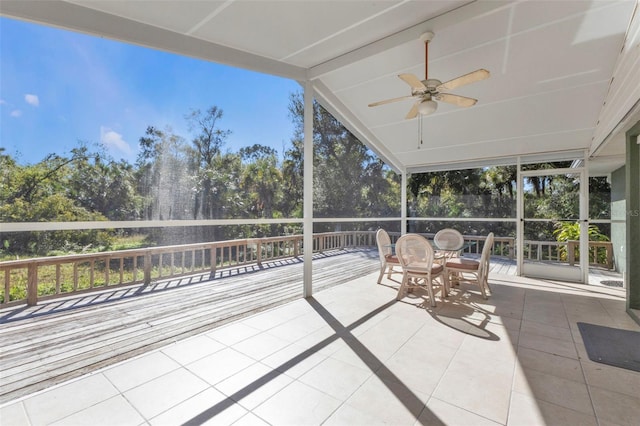 1811 Music Ln, North Port, FL 34286 - sunroom with ceiling fan, vaulted ceiling, view of wooded area, and outdoor dining area