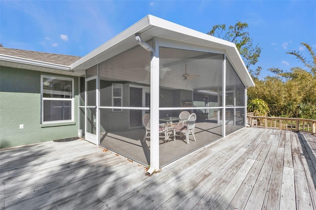 wooden deck with a sunroom