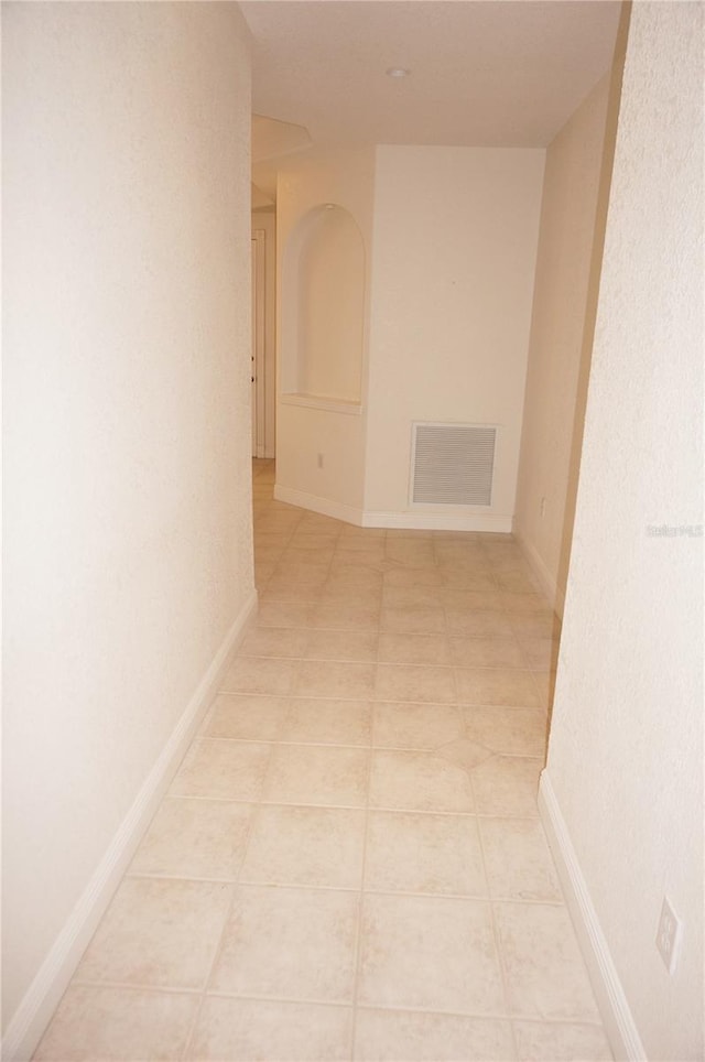 hall with light tile patterned floors