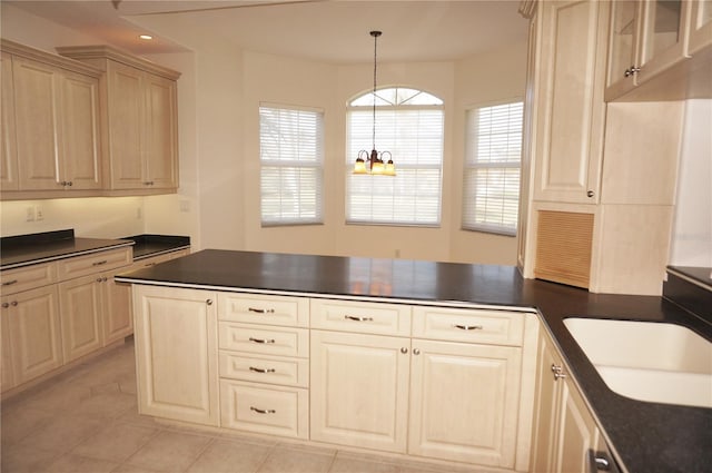 kitchen featuring pendant lighting, sink, a wealth of natural light, and a chandelier