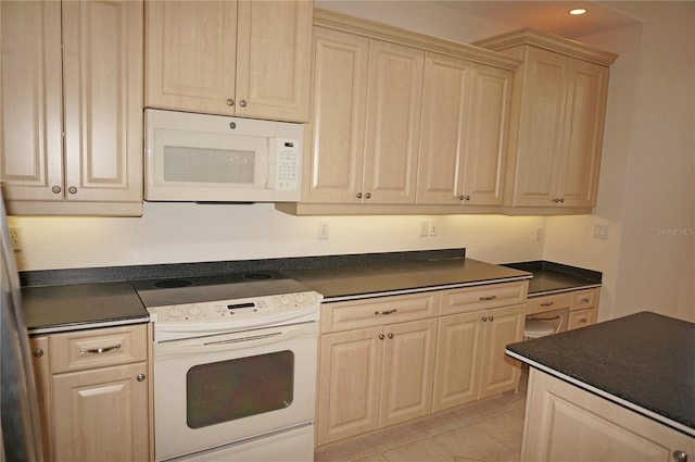 kitchen with light tile patterned floors and white appliances