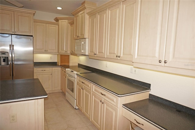 kitchen featuring light brown cabinets, white appliances, and light tile patterned floors