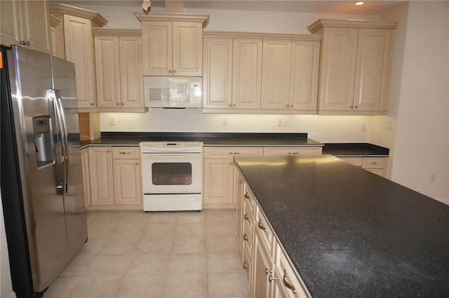 kitchen with light tile patterned flooring and white appliances