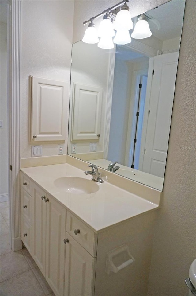 bathroom featuring tile patterned floors, vanity, and a textured ceiling