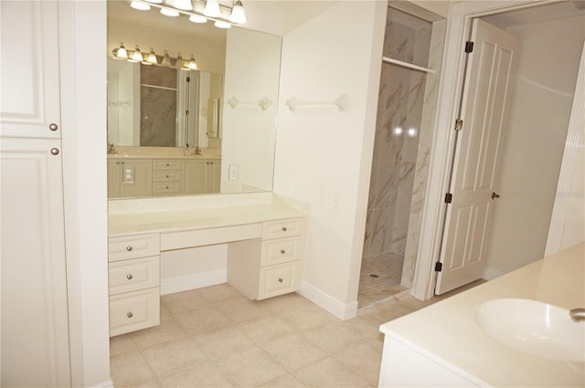 bathroom with tiled shower and vanity