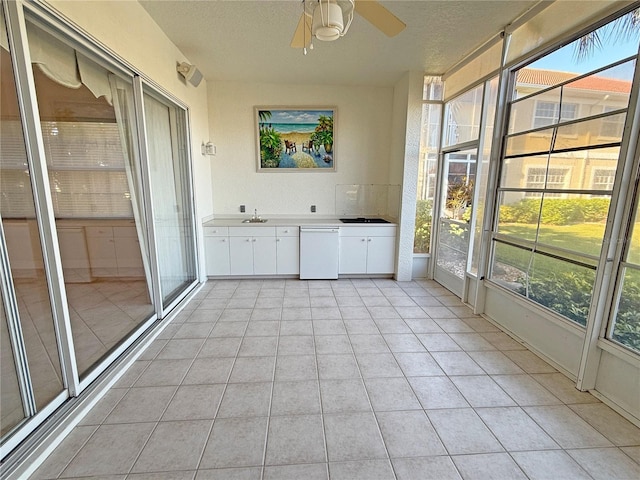 unfurnished sunroom featuring ceiling fan