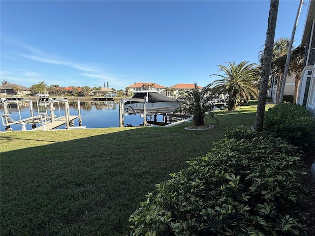 dock area featuring a water view and a yard