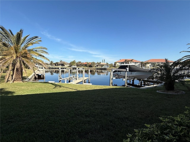 view of dock featuring a water view and a lawn