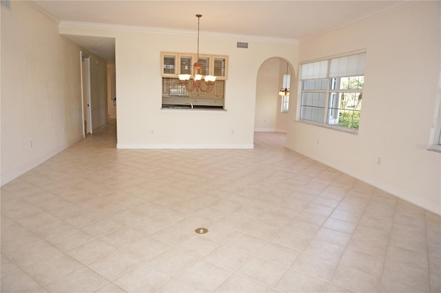 spare room featuring sink, a notable chandelier, and ornamental molding