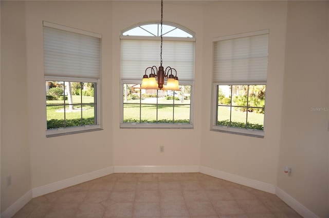 unfurnished room with a chandelier