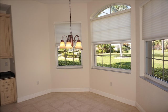 unfurnished dining area with a chandelier