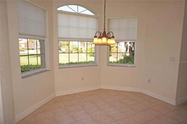 unfurnished room featuring a notable chandelier