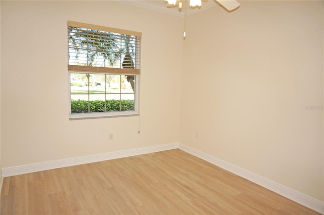 empty room with ceiling fan, wood-type flooring, and ornamental molding