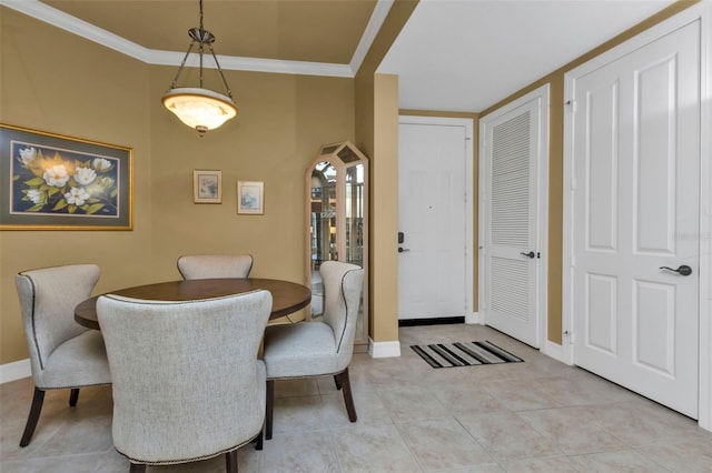 dining room with light tile patterned floors and ornamental molding