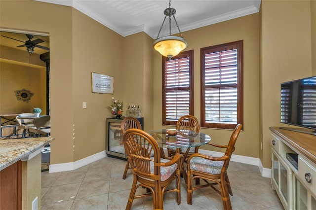 tiled dining room featuring ceiling fan and ornamental molding