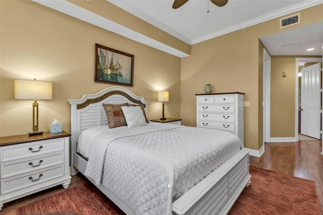 bedroom featuring dark hardwood / wood-style floors, ceiling fan, and crown molding