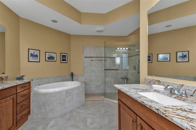 bathroom with tile patterned flooring, vanity, and shower with separate bathtub