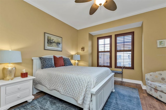 bedroom with dark hardwood / wood-style floors, ceiling fan, and ornamental molding