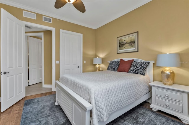 bedroom with ceiling fan and dark hardwood / wood-style floors