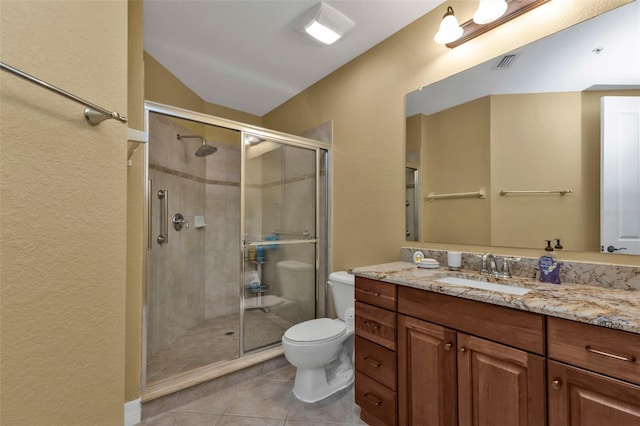 bathroom with tile patterned floors, walk in shower, vanity, and toilet