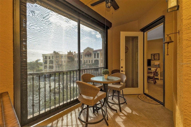 sunroom featuring ceiling fan and vaulted ceiling