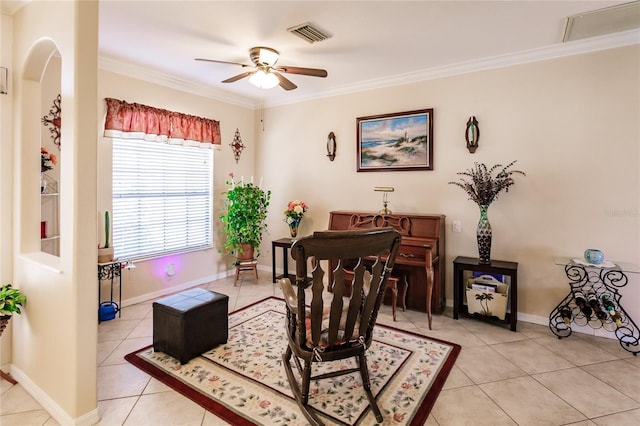 living area with light tile patterned floors, ceiling fan, and ornamental molding