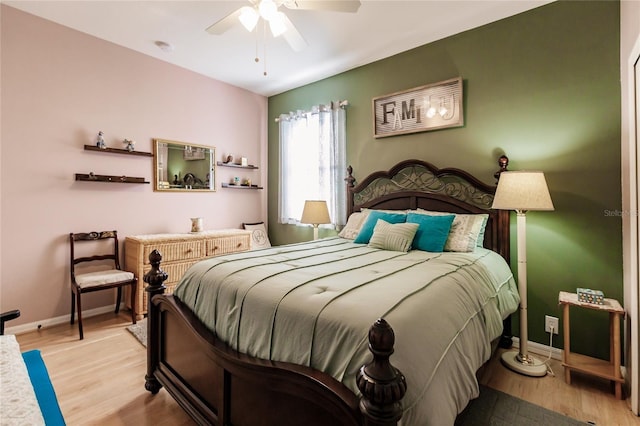 bedroom with ceiling fan and light hardwood / wood-style floors