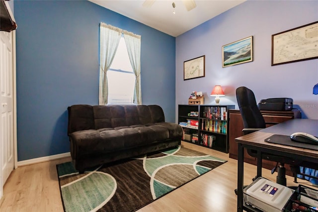 home office with ceiling fan and light hardwood / wood-style floors