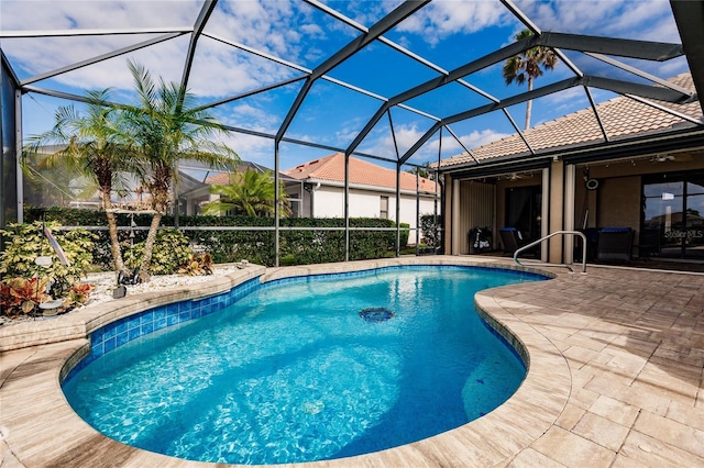 view of pool featuring a patio area, ceiling fan, and glass enclosure