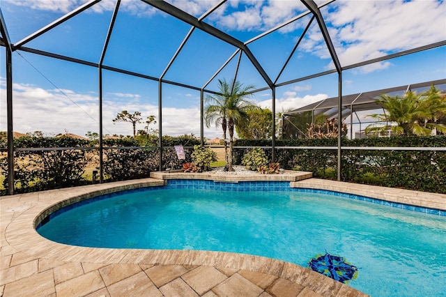 view of pool featuring glass enclosure