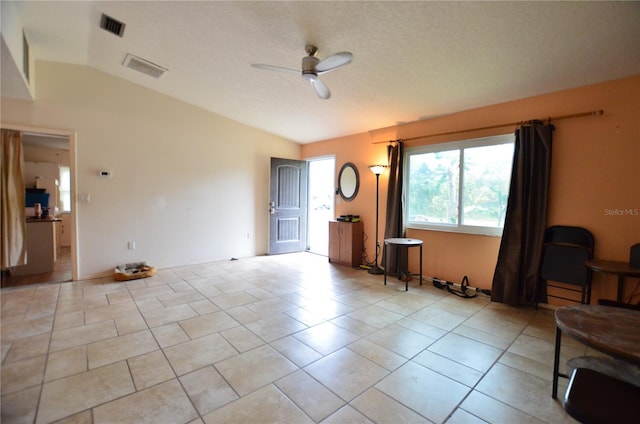 unfurnished living room with light tile patterned floors, ceiling fan, and lofted ceiling