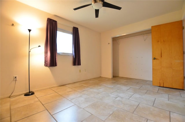 unfurnished bedroom with ceiling fan and a closet