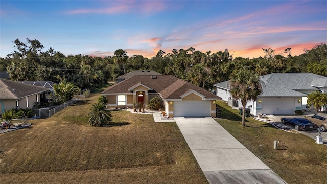 ranch-style home with a yard and a garage