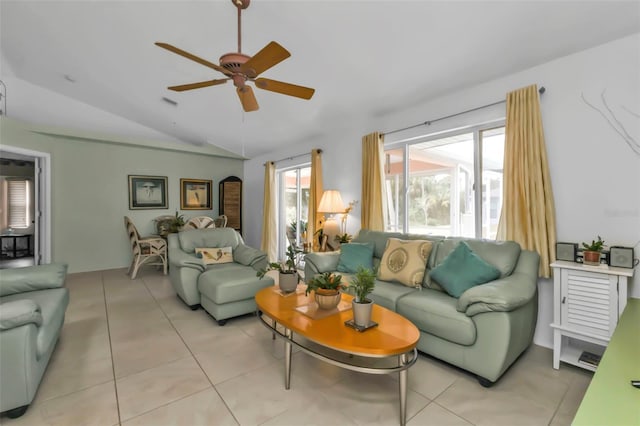 tiled living room featuring ceiling fan and vaulted ceiling