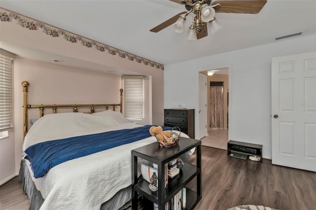 bedroom with ceiling fan and dark wood-type flooring