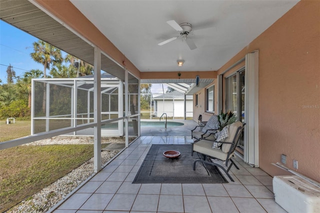 view of patio / terrace with a fire pit, ceiling fan, and a lanai