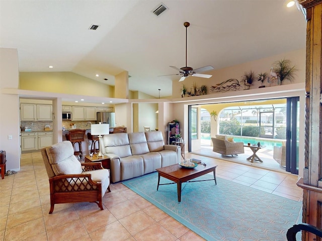 living room with light tile patterned floors, high vaulted ceiling, and ceiling fan