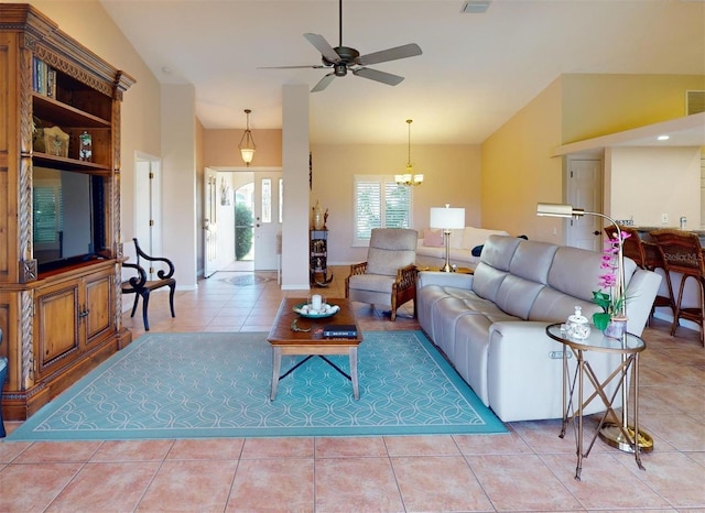 living room featuring tile patterned floors and ceiling fan with notable chandelier